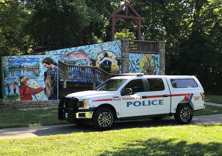 SWT police supervisor truck parked in front of mural.